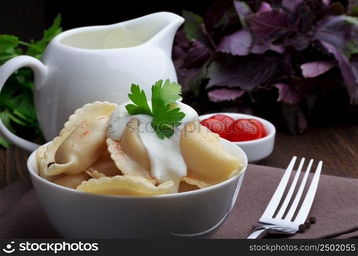Meat dumplings with sour cream, traditional pelmeni or varenyky dish