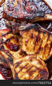 Meat grilled spare ribs on wooden cutting board.Pork rack grilled.Pork ribs in barbecue sauce. Fresh grilled meat