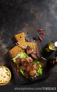 meat kebab with salad on wooden board