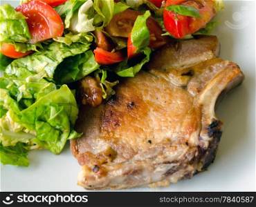 Meat on the bone and salad