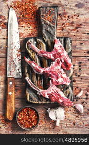 meat on the rib of lamb. raw meat on the rib of lamb in hot spices on the kitchen board