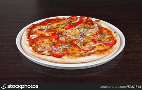 meat pizza with vegetables at the table