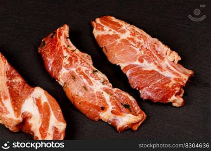 Meat. Raw pieces of pork with a black background. Selective focus. Top view. raw and fresh pork meat. Meat. Raw pieces of pork a black background. Selective focus. Top view.