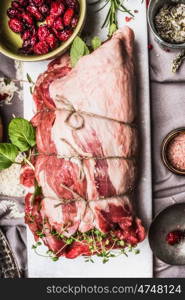 Meat roast preparation with cooking herbs,spices, Pine nuts and cranberries , top view, close up