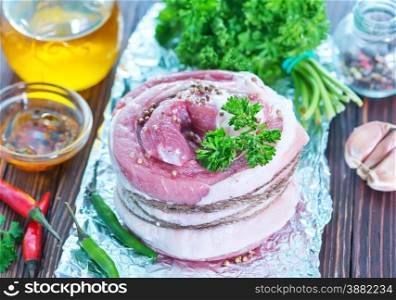 meat roll with salt and spice on the foil