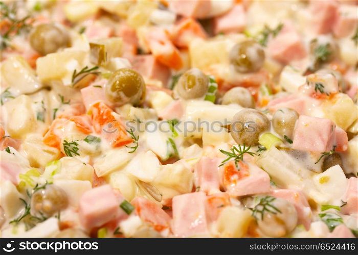 Meat salad with a peas, carrots and a potato. Meat salad
