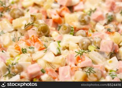 Meat salad with a peas, carrots and a potato. Meat salad