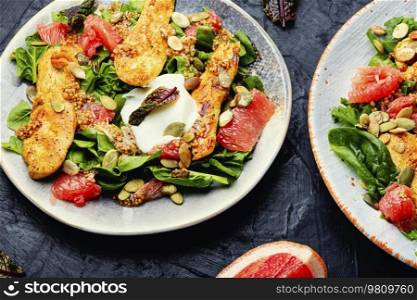 Meat salad with chicken breast, lettuce and citrus fruits. Healthy and detox food concept. Fresh salad with chicken breast, herbs and fruits