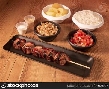  meat skewer with side dishes on the table
