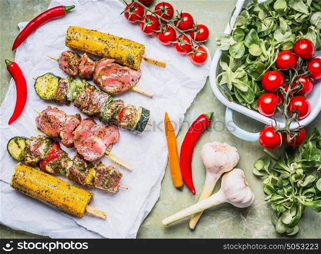 Meat Skewers for grill with vegetables , corn ears and condiment, preparation on rustic background , top view