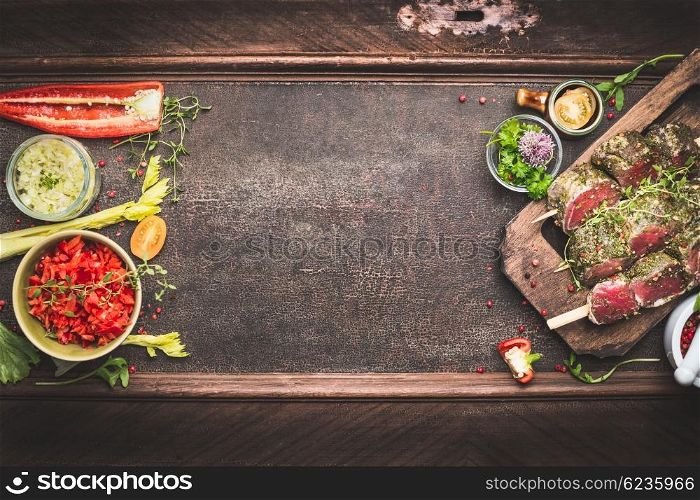 Meat skewers with vegetables and fresh flavoring, preparation for grill or BBQ on dark vintage background, top view, banner