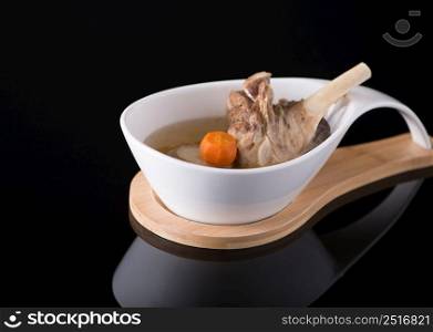 meat soup in a white bowl on a black background, isolated. dish on black background