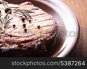 Meat steak roasted on grill with spices on the plate