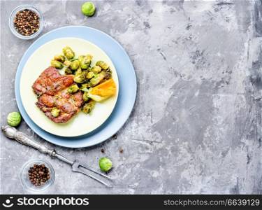 Meat steak with baked cabbage and pepper on a plate. Meat steak with vegetables