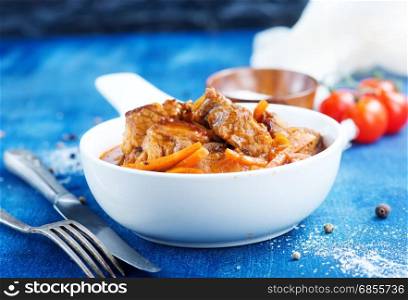 meat stew in white bowl and on a table