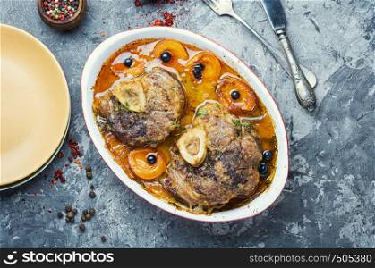 Meat stew with apricot.Ossobuco,dish of Italian cuisine.Stewed calf leg. Christmas meat cooked in apricot sauce