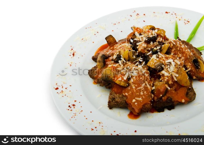 Meat under tasty sauce in plate