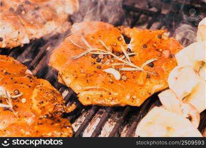 meat with  herbs grilling on barbecue