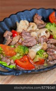 meat with vegetables at frying pan. meat with vegetables