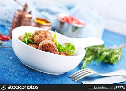 meatballs in bowl and on a table