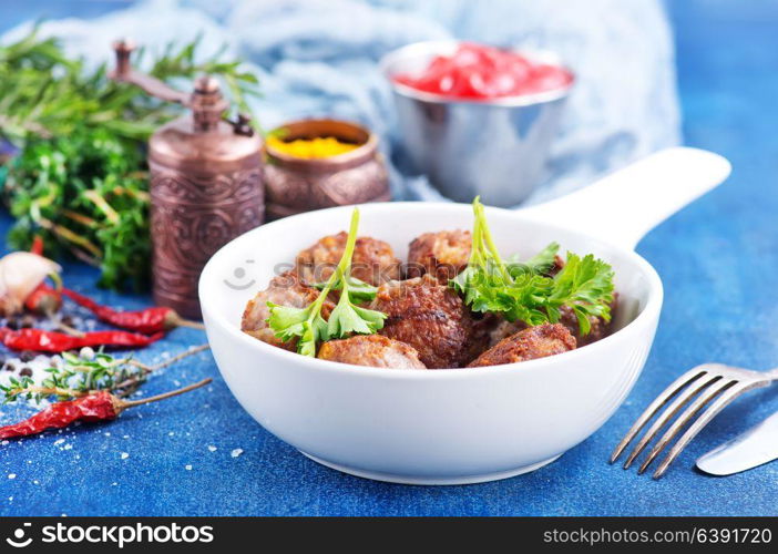 meatballs in bowl and on a table