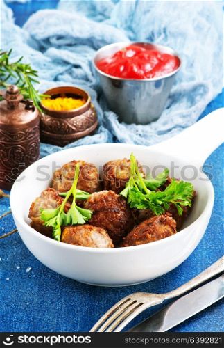 meatballs in bowl and on a table