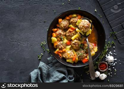 Meatballs in sauce with vegetables, top view
