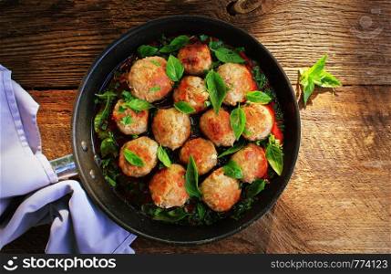 Meatballs in sweet and sour tomato sauce on rustic table. Top view .. Meatballs in sweet and sour tomato sauce on rustic table. Top view