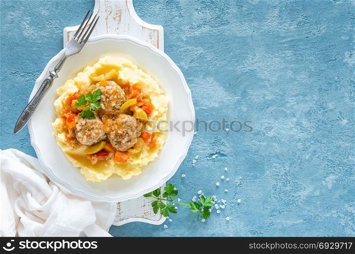 Meatballs in vegetable sauce with mashed potato, top view