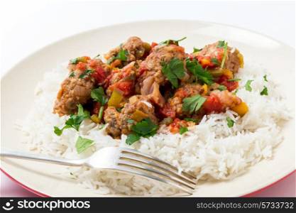 Meatballs Smyrna cooked with a sauce of cumin, red and yellow capsicums and tomatoes, making a colourful and tasty dish
