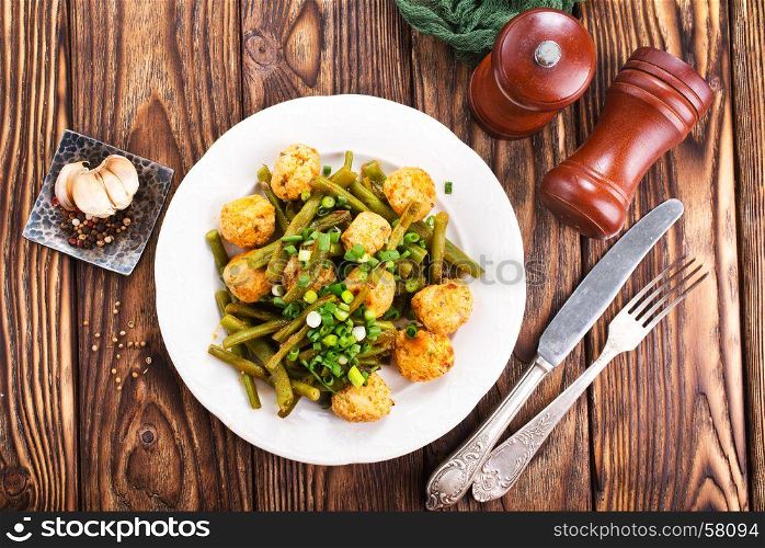 meatballs with green beans on the plate