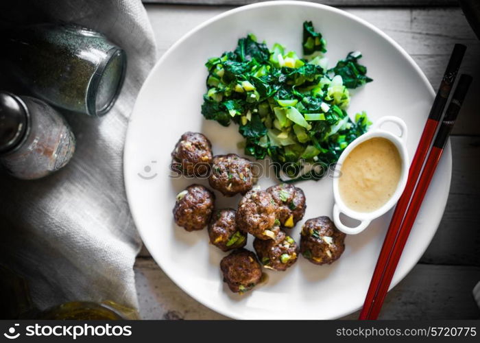 Meatballs with green salad and honey mustard sauce