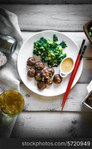 Meatballs with green salad and honey mustard sauce