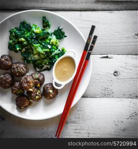 Meatballs with green salad and honey mustard sauce