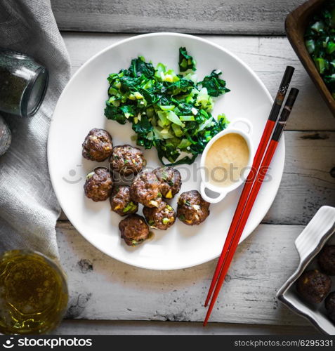 Meatballs with green salad and honey mustard sauce