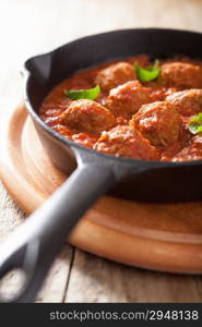 meatballs with tomato sauce in black pan