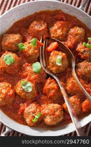 meatballs with tomato sauce in pan with spoon