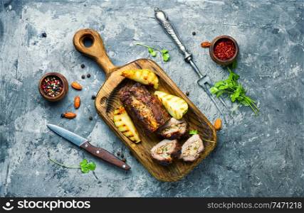 Meatloaf with pears and almonds.Beef meatloaf on cutting board. Meatloaf with fruit and nuts