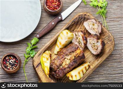 Meatloaf with pears and almonds.Beef meatloaf on wooden table. Christmas meatloaf with fruit and nuts