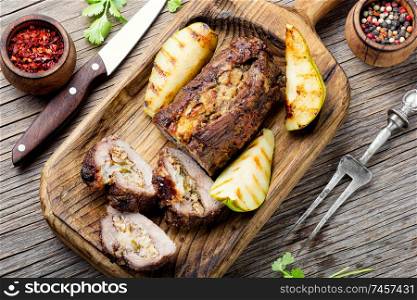 Meatloaf with pears and almonds.Beef meatloaf on wooden table. Meatloaf with fruit and nuts