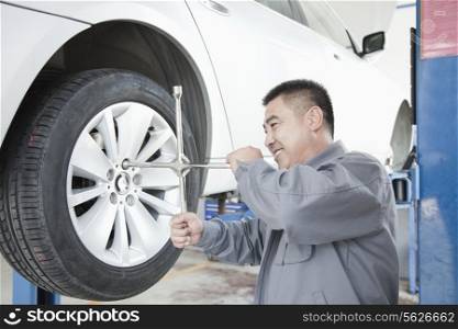 Mechanic Adjusting Tire