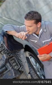 Mechanic assessing car