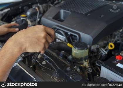 Mechanic checks and cleans the car&rsquo;s engine.