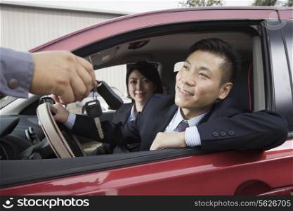 Mechanic Giving Car Keys to Couple