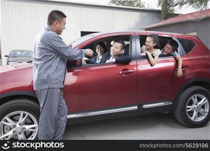 Mechanic Giving Car Keys to Family