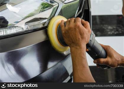 Mechanic hand holding the car polish