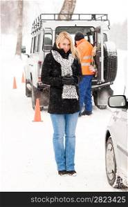 Mechanic helping woman with broken car snow assistance road winter