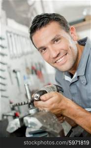 Mechanic holding drill