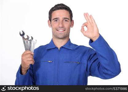 Mechanic making OK gesture