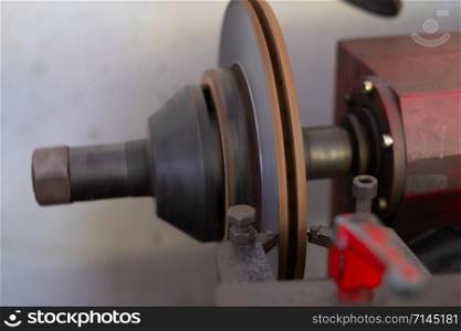 Mechanic man repairing brake use lathe tool polishing disc brakes of cars working automatic